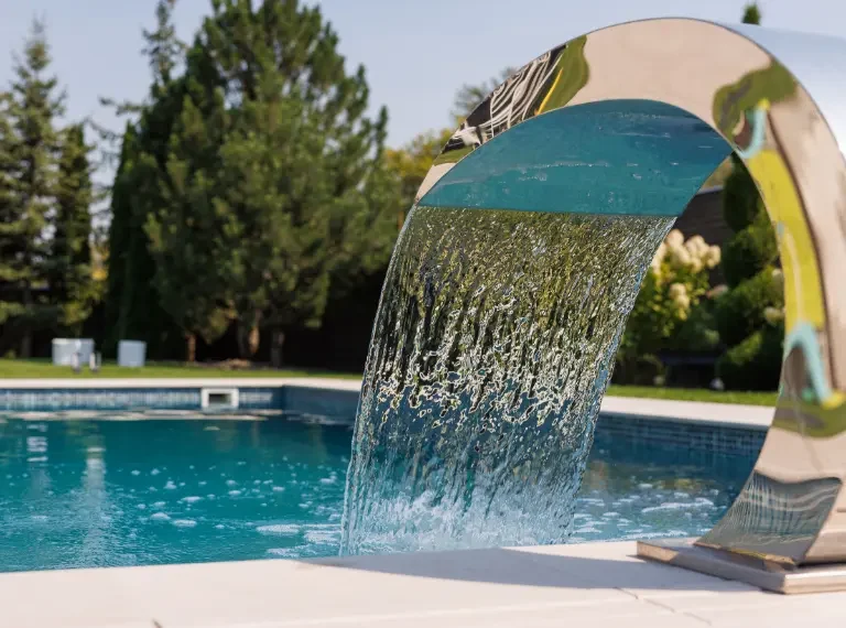 Sheer Descent Water Feature pouring into Backyard Swimming Pool